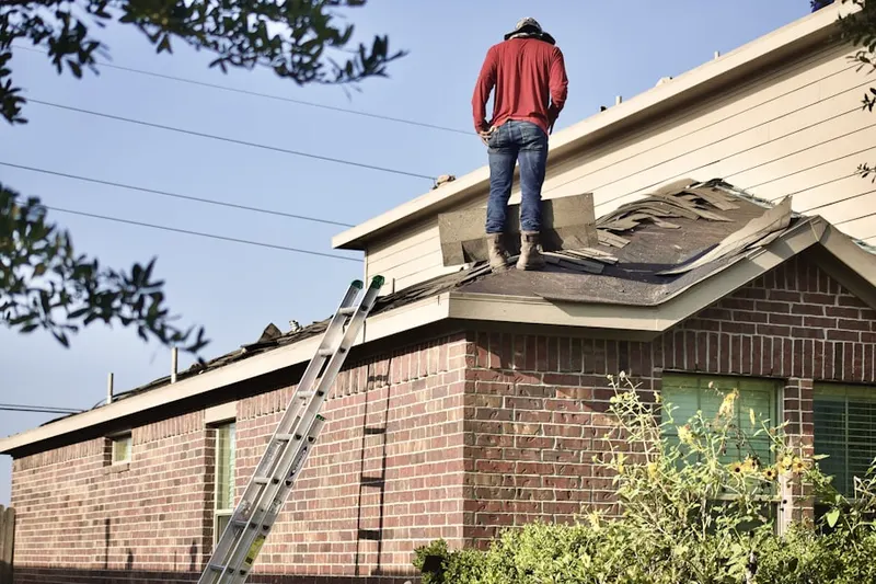 Professional roofer working on a residential roof in Rosedale Village